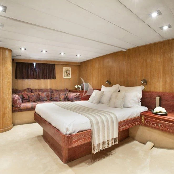 a room with a bed and a wood wall aboard LADY JERSEY Yacht for Charter