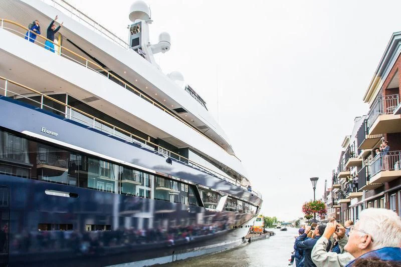 a group of people on a sidewalk next to a large cruise ship aboard LONIAN Yacht for Sale