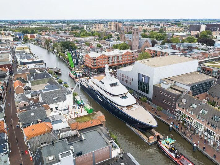 a city with a river and boats aboard LONIAN Yacht for Sale