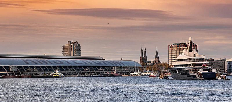 a body of water with boats and buildings in the background aboard LONIAN Yacht for Sale