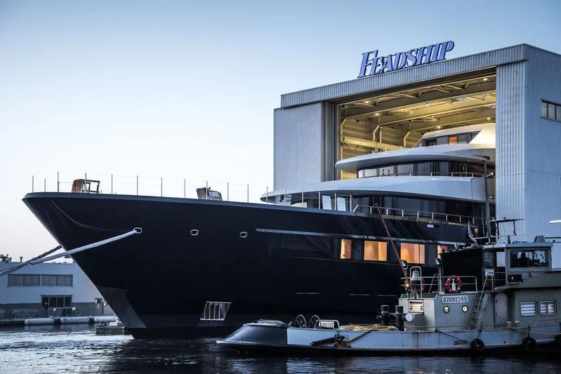 a large black boat docked aboard LONIAN Yacht for Sale