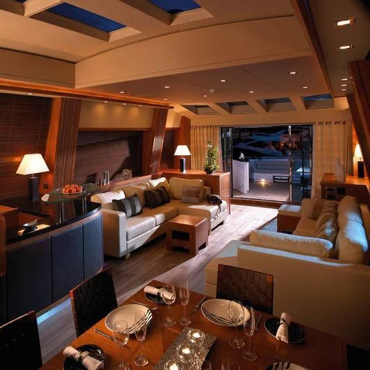 a living room with a couch and a table aboard CASINO ROYALE Yacht for Sale