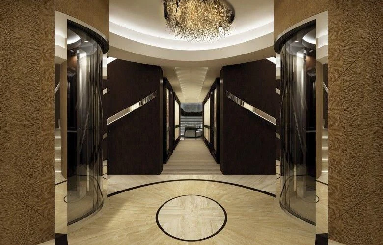 a large room with a large black cabinet and a round table with a gold plate on it aboard MARYAH Yacht for Sale