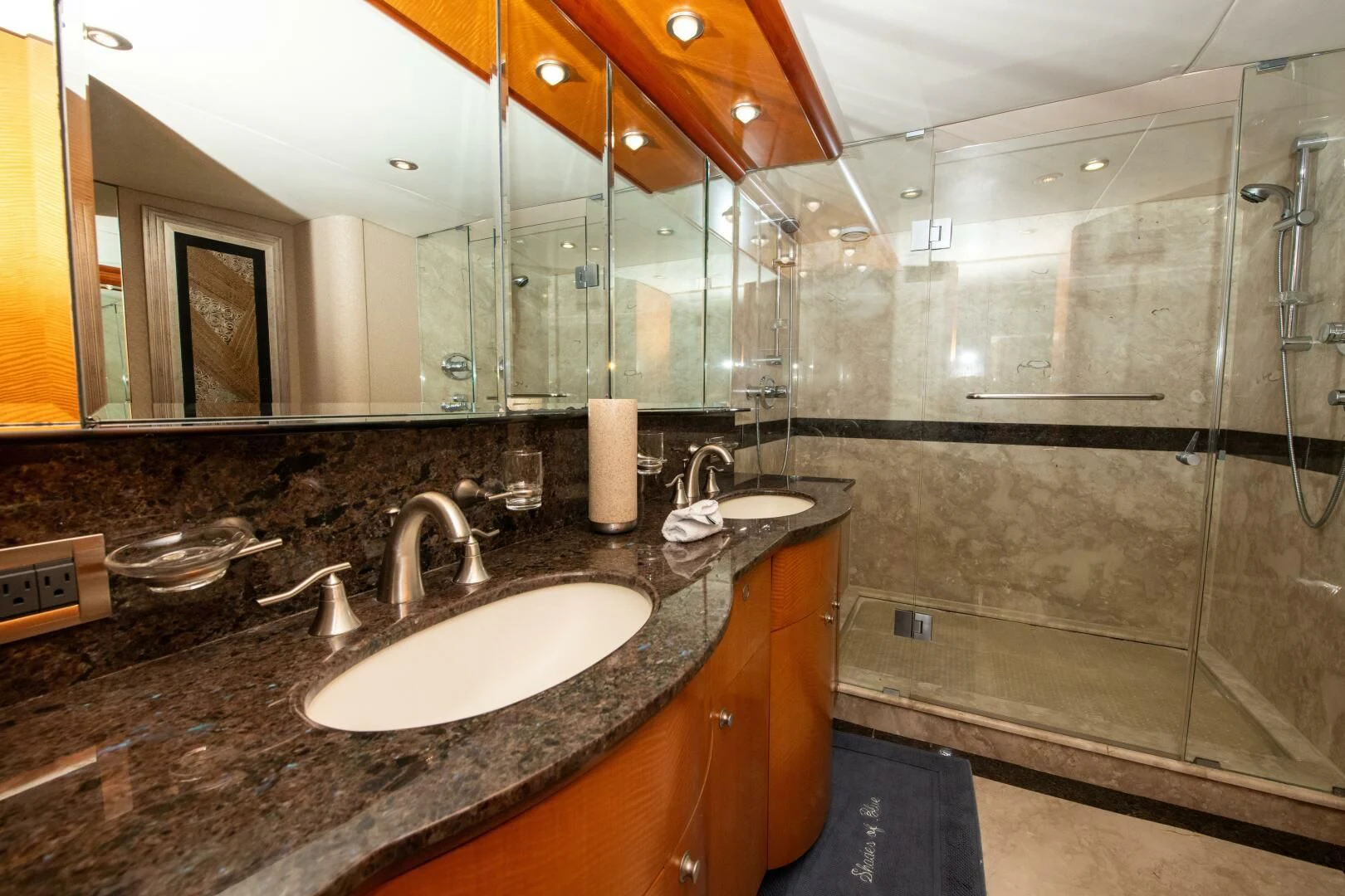 a bathroom with a large glass shower aboard STARFIRE Yacht for Sale