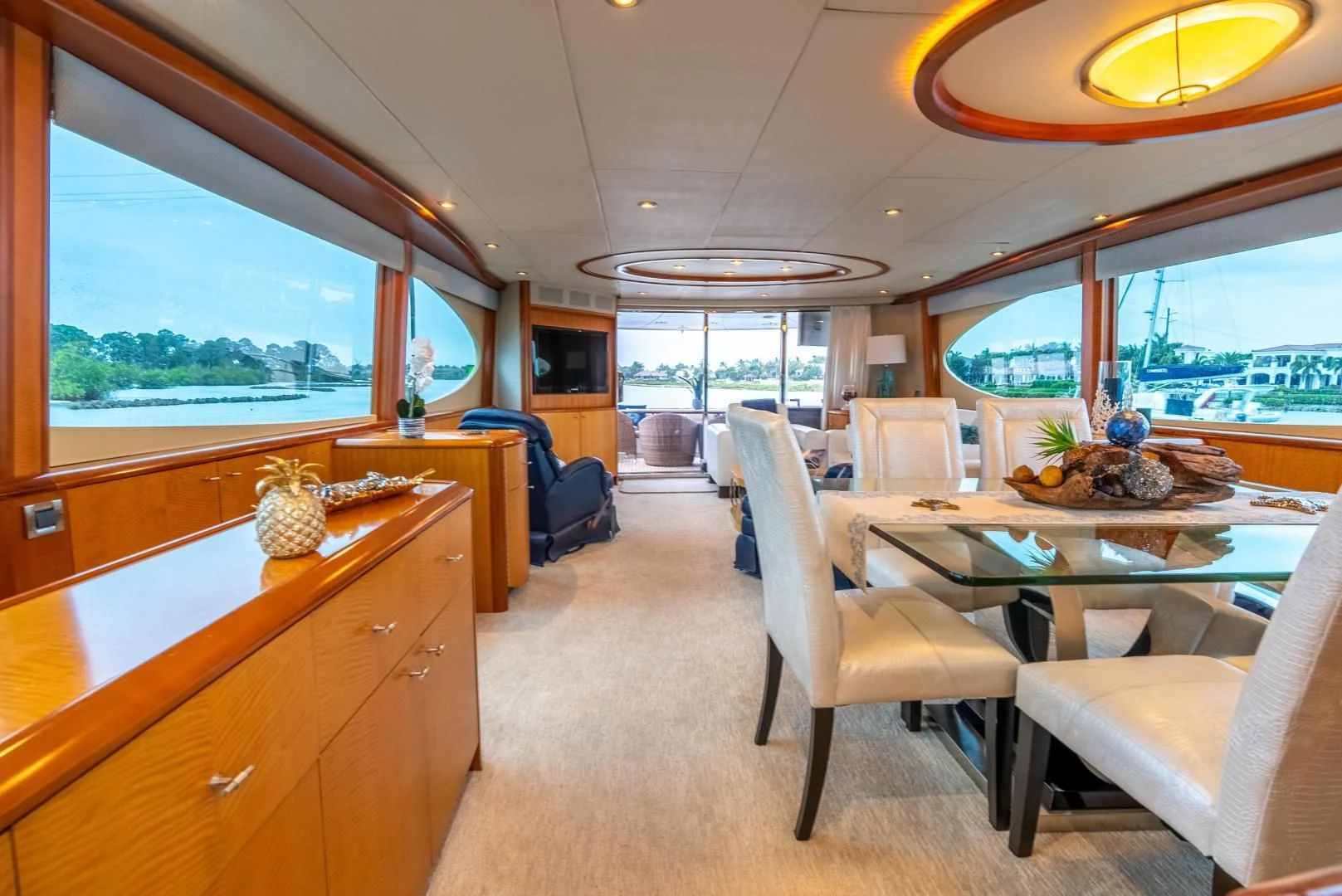 a large room with a table and chairs aboard STARFIRE Yacht for Sale