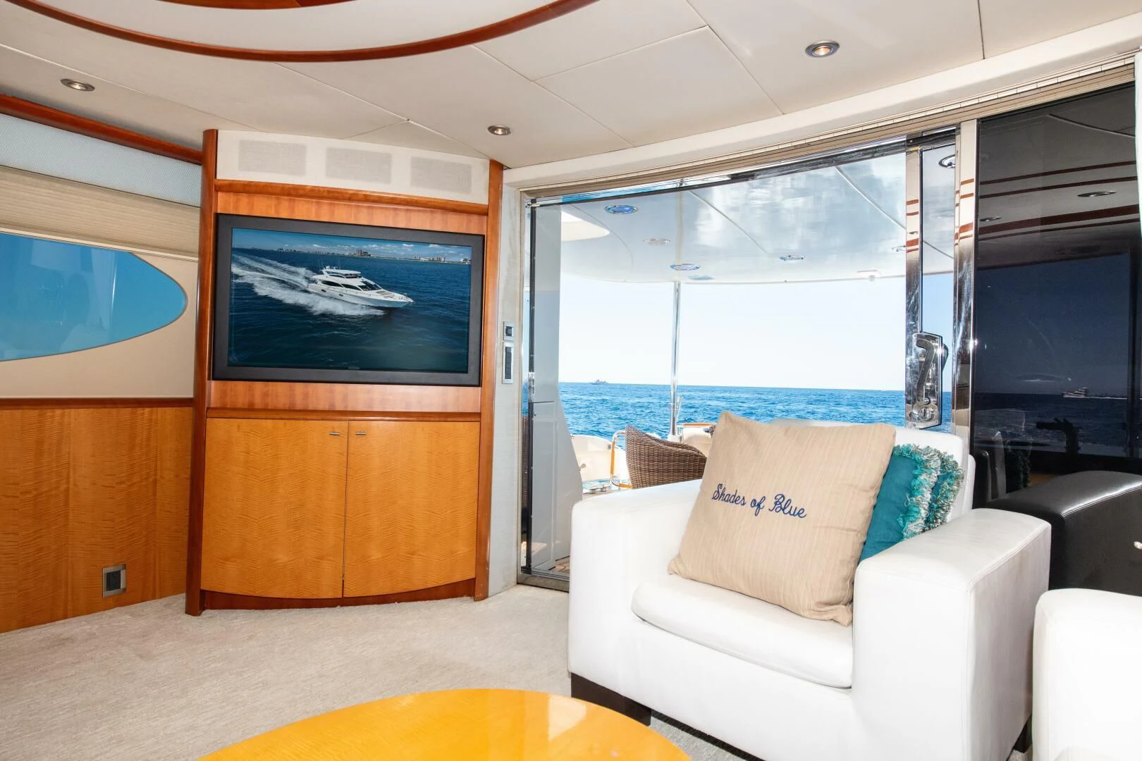 a room with a tv and furniture aboard STARFIRE Yacht for Sale