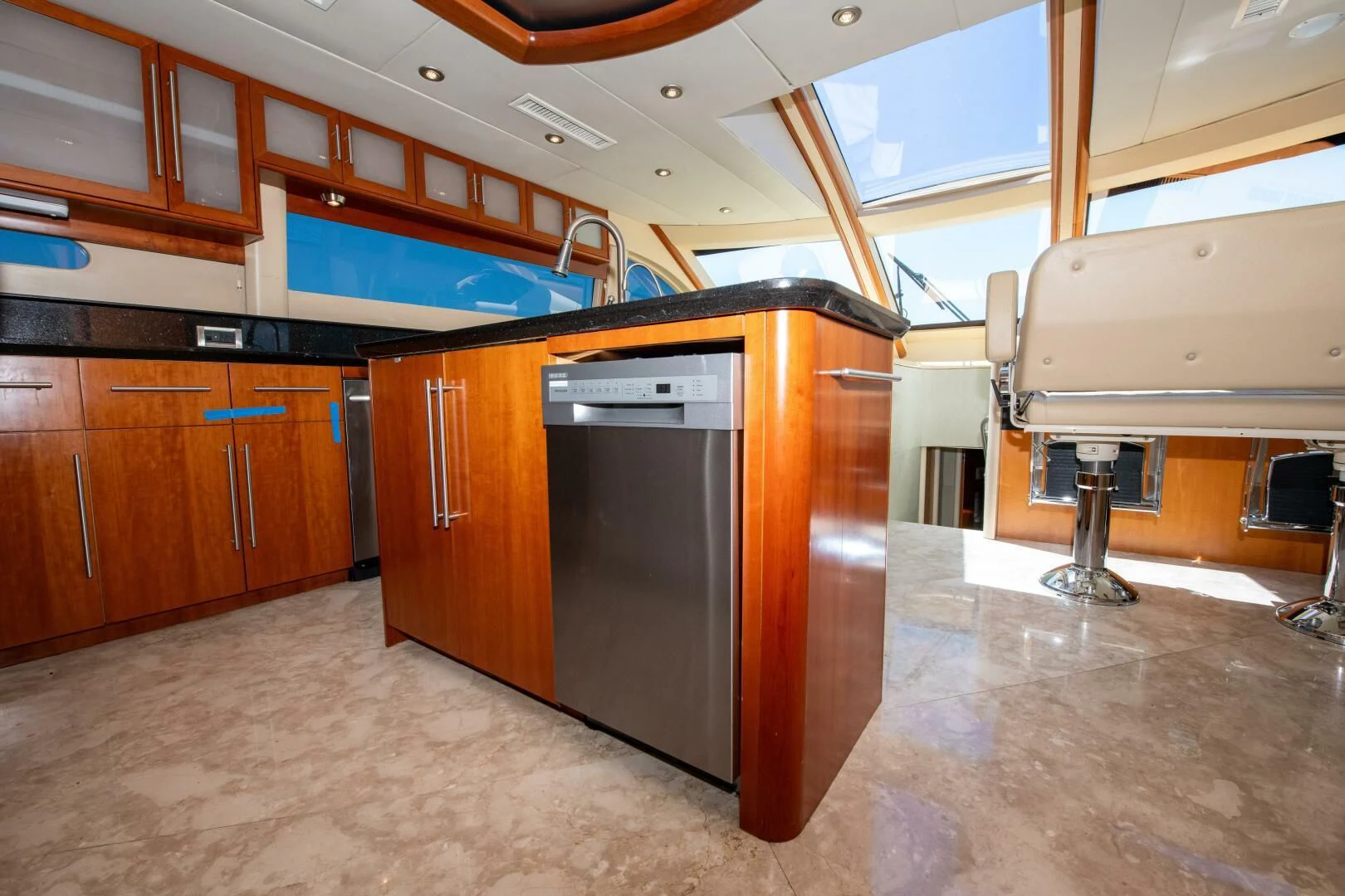 a kitchen with wooden cabinets aboard STARFIRE Yacht for Sale