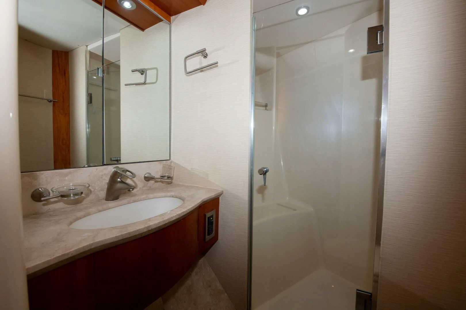 a bathroom with a glass shower aboard STARFIRE Yacht for Sale