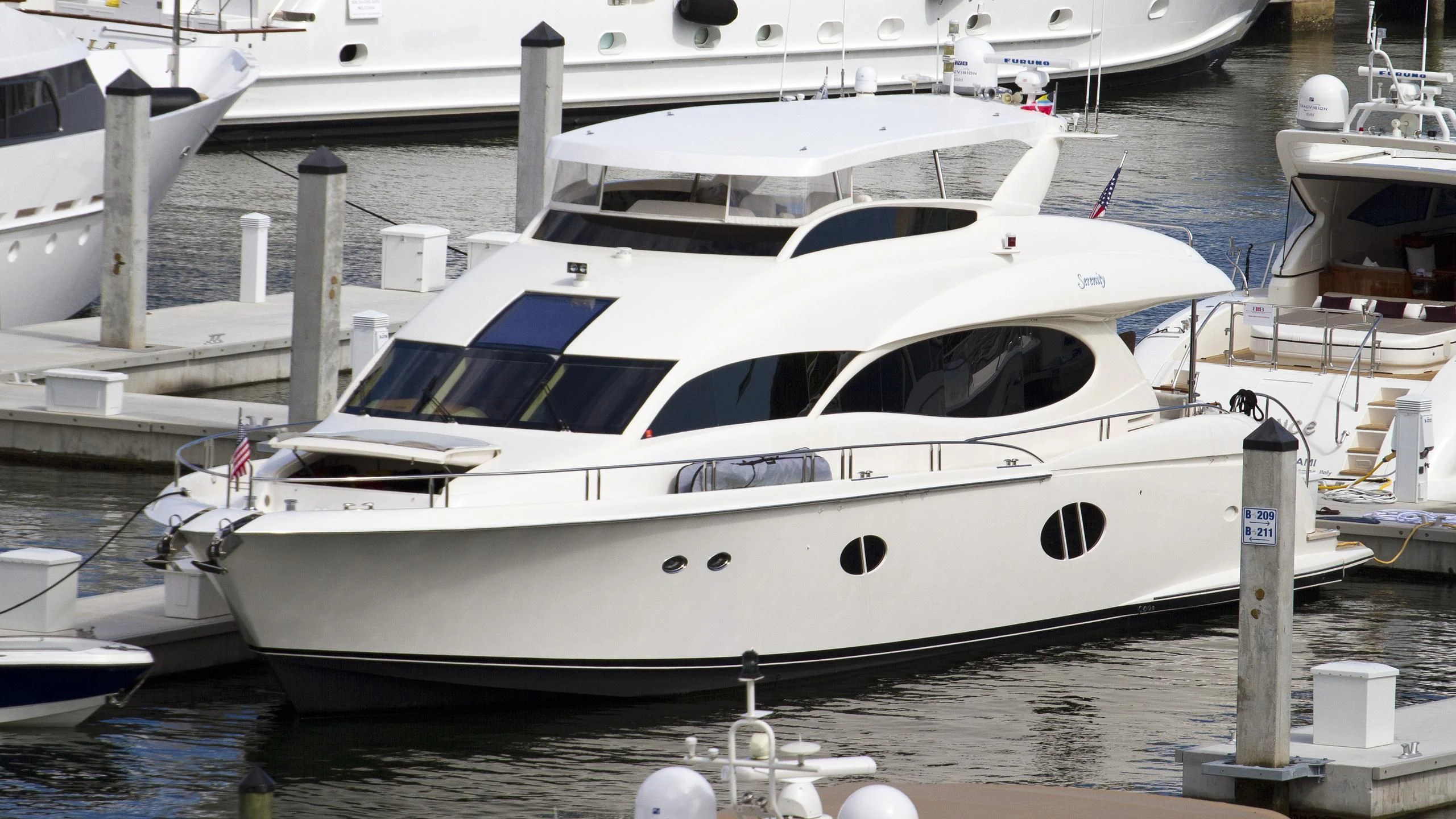 a white boat in a harbor aboard STARFIRE Yacht for Sale