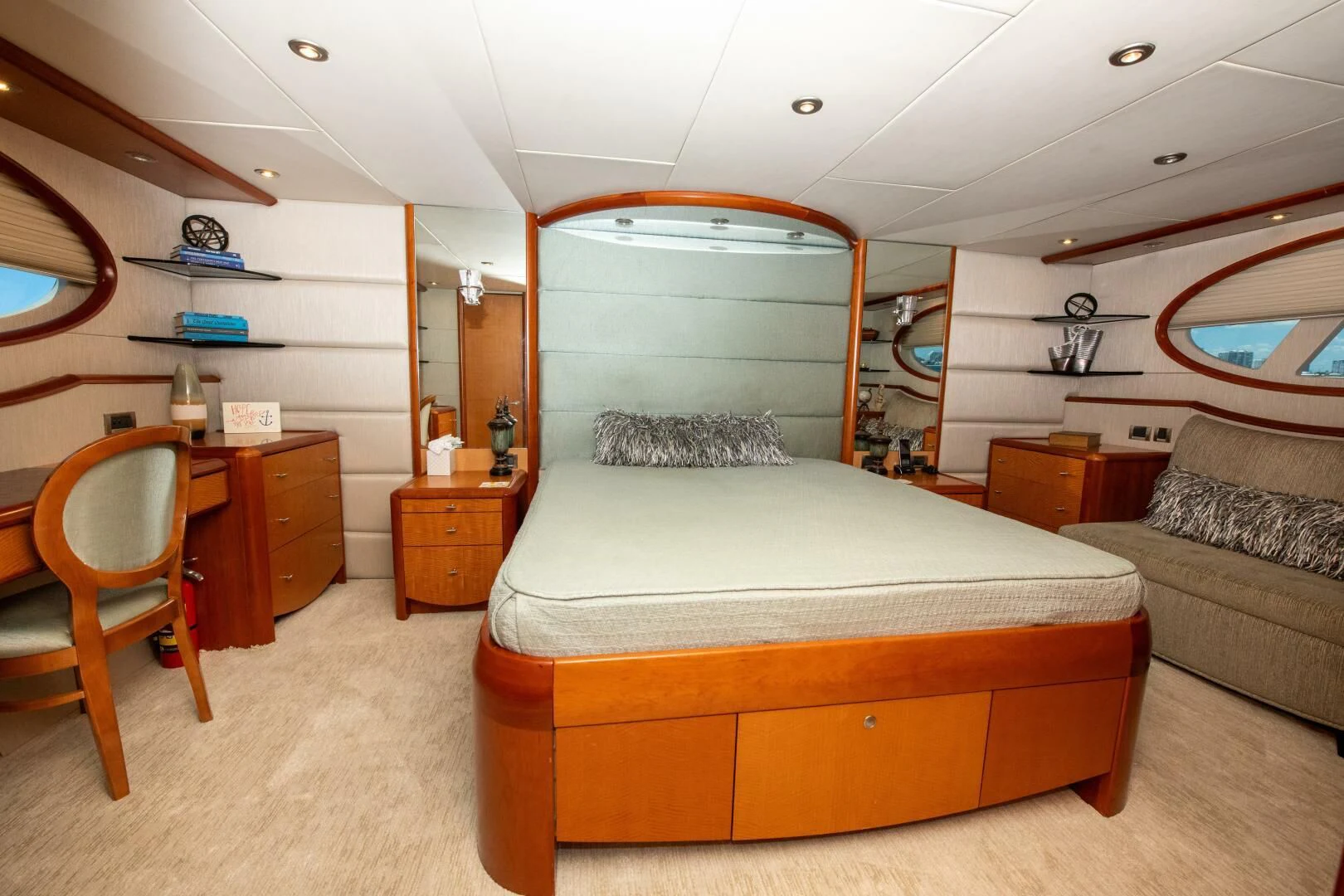 a bedroom with a bed and a couch aboard STARFIRE Yacht for Sale