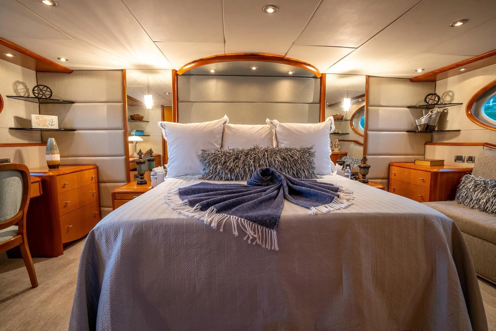 a bed with a blue comforter aboard STARFIRE Yacht for Sale