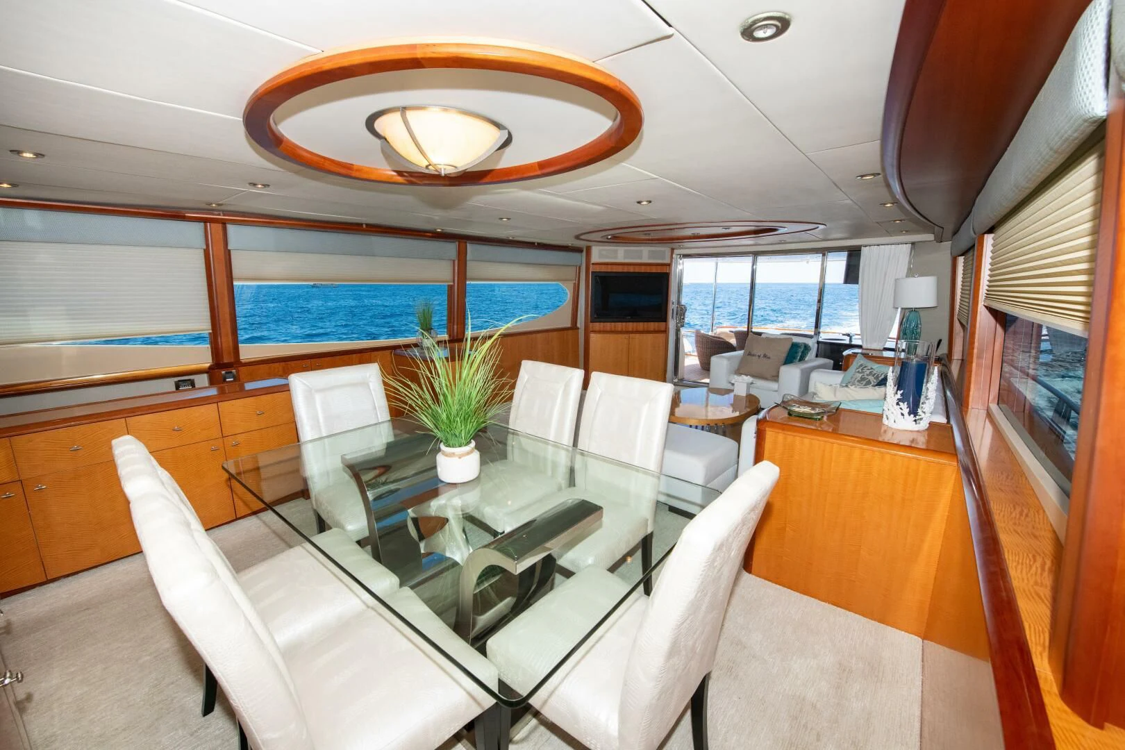 a room with a table chairs and a large window aboard STARFIRE Yacht for Sale