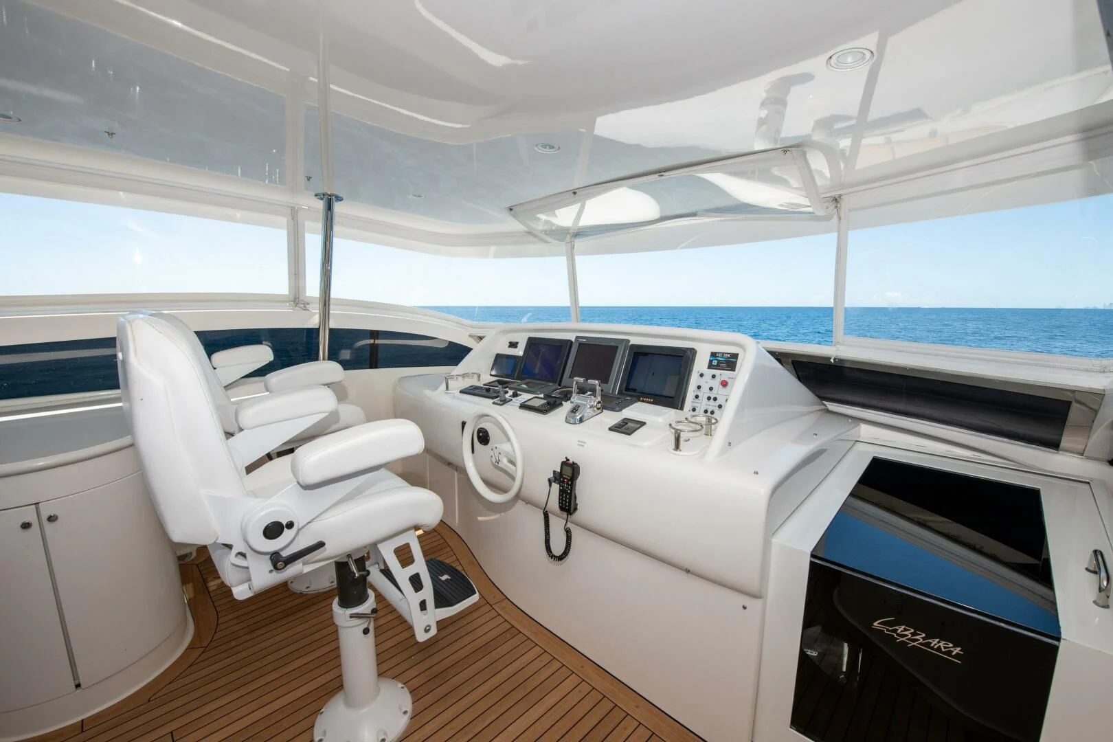 a white yacht with a seat aboard STARFIRE Yacht for Sale