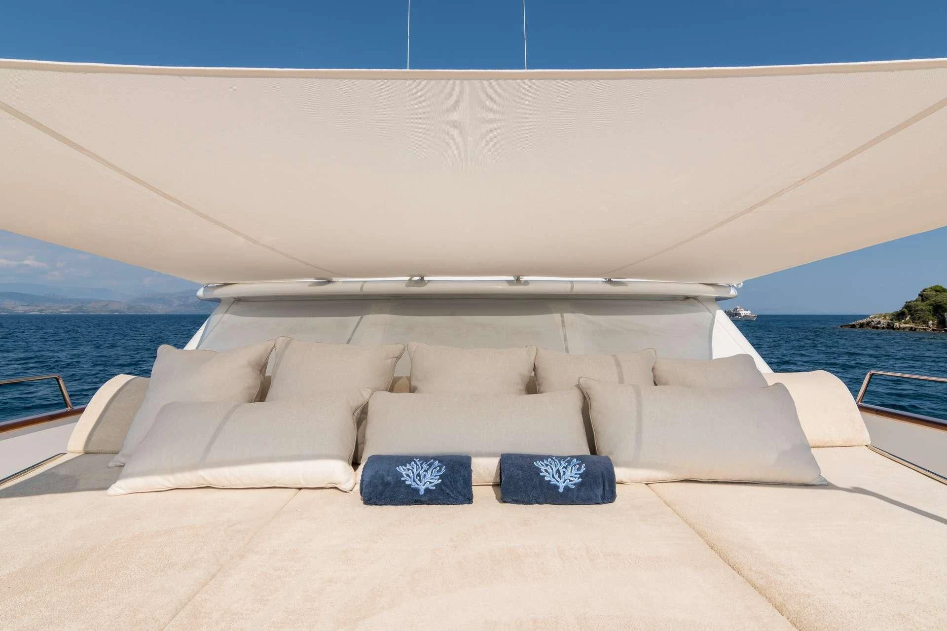 a white lounge chair on a beach aboard ENDLESS SUMMER Yacht for Sale