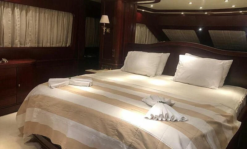 a bed with white sheets aboard ENDLESS SUMMER Yacht for Sale