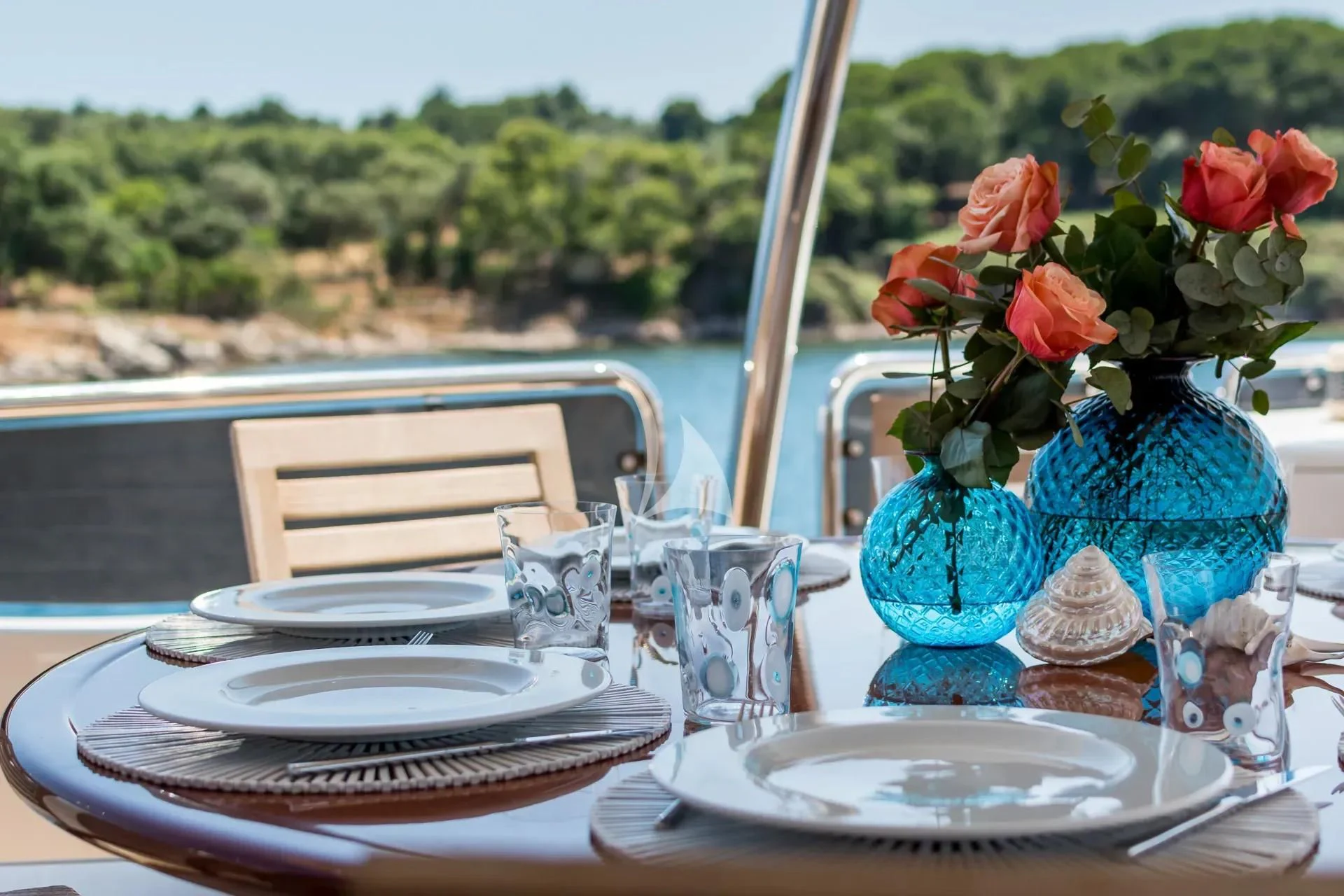 a table with plates and glasses on it aboard ENDLESS SUMMER Yacht for Sale