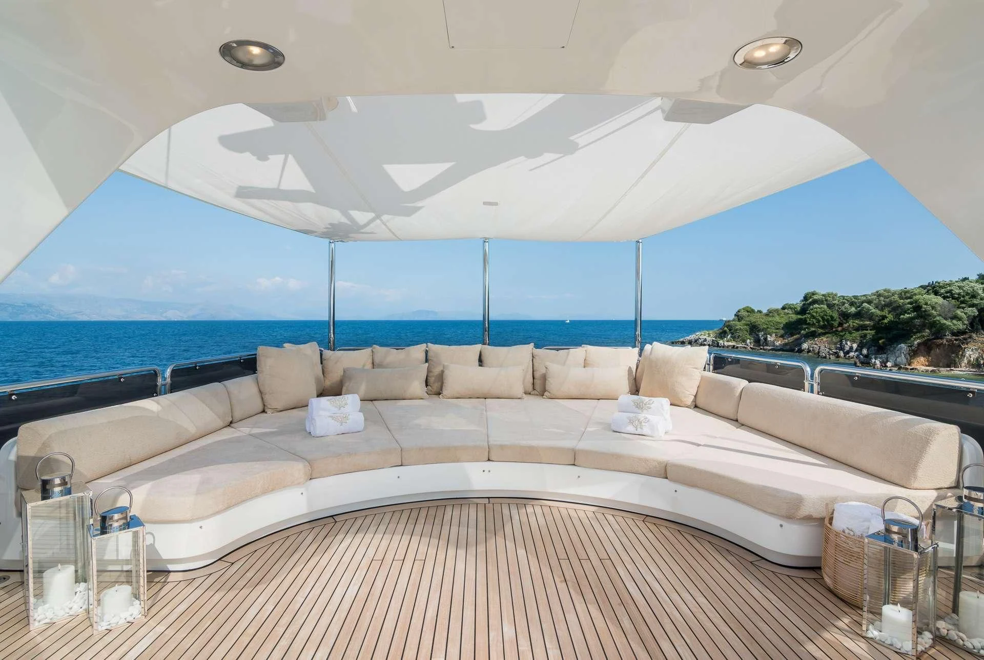 a large white lounge chair next to a large window overlooking a beach aboard ENDLESS SUMMER Yacht for Sale