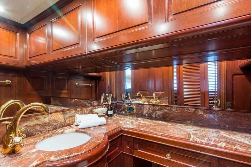 a bathroom with wooden cabinets aboard ENDLESS SUMMER Yacht for Sale