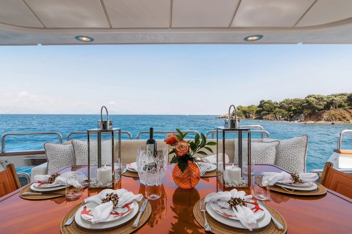a table set with plates and glasses aboard ENDLESS SUMMER Yacht for Sale