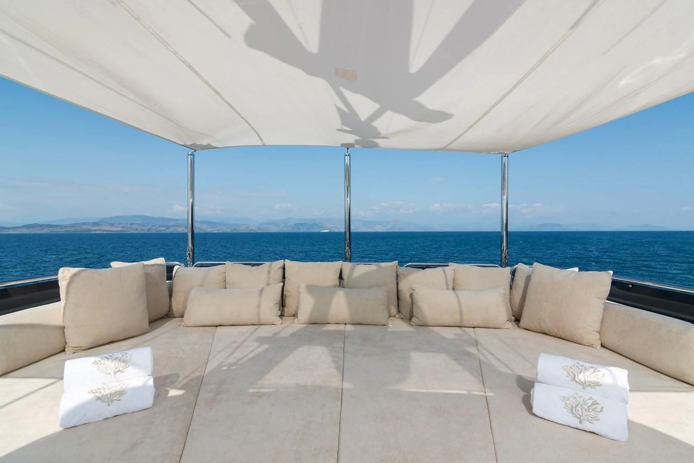 a couch on a patio by the water aboard ENDLESS SUMMER Yacht for Sale