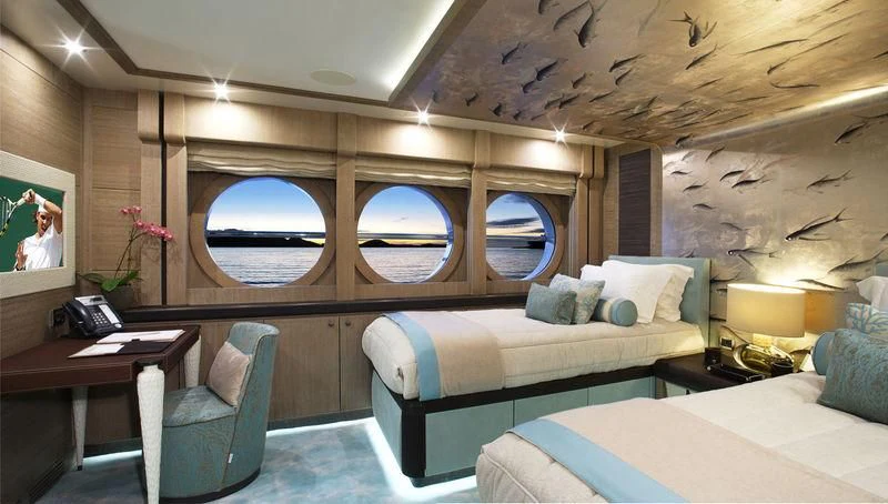a room with a bed and a desk aboard LADY M Yacht for Sale
