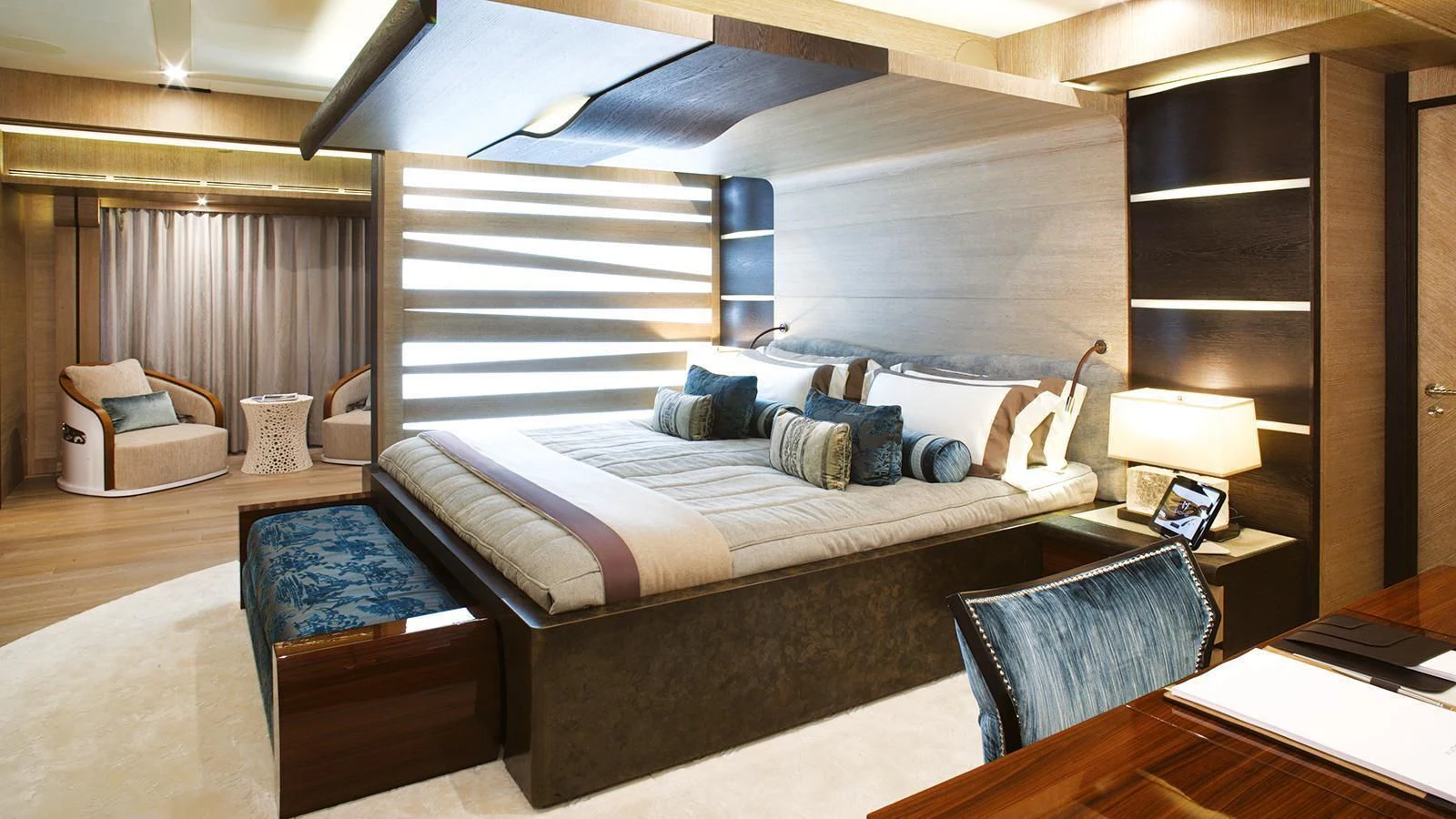a bedroom with a bed and a desk aboard LADY M Yacht for Sale