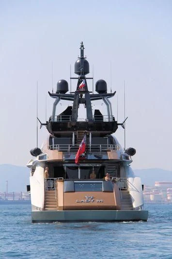 a large ship in the water with Thomas Point Shoal Light in the background aboard LADY M Yacht for Sale