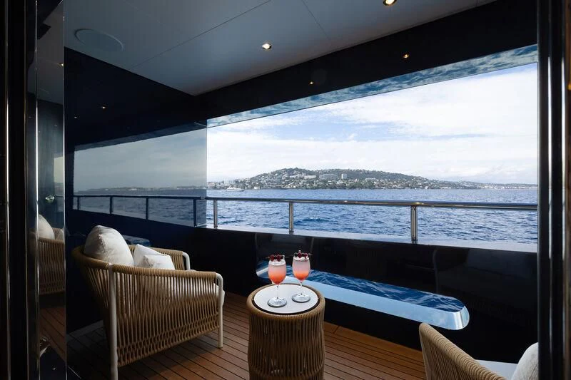 a room with a bed and a table and chairs aboard ZAZOU Yacht for Sale