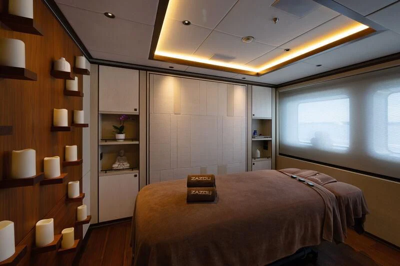 a bedroom with a bed and a bookcase aboard ZAZOU Yacht for Sale