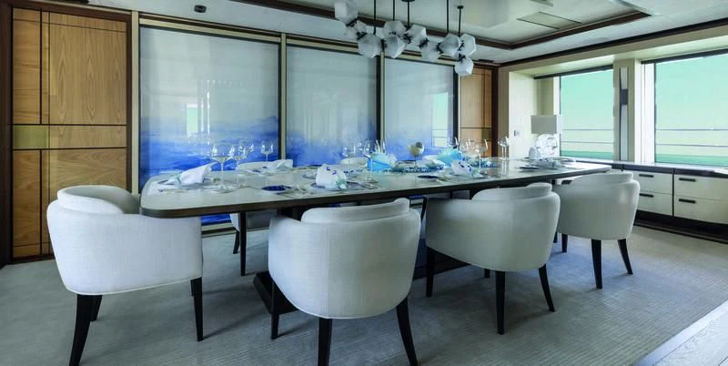 a large kitchen with white chairs aboard ZAZOU Yacht for Sale