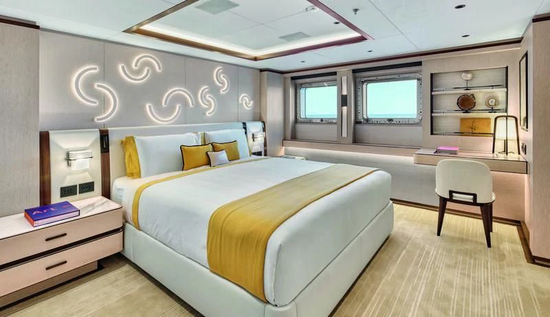a bedroom with a bed and desk aboard ZAZOU Yacht for Sale