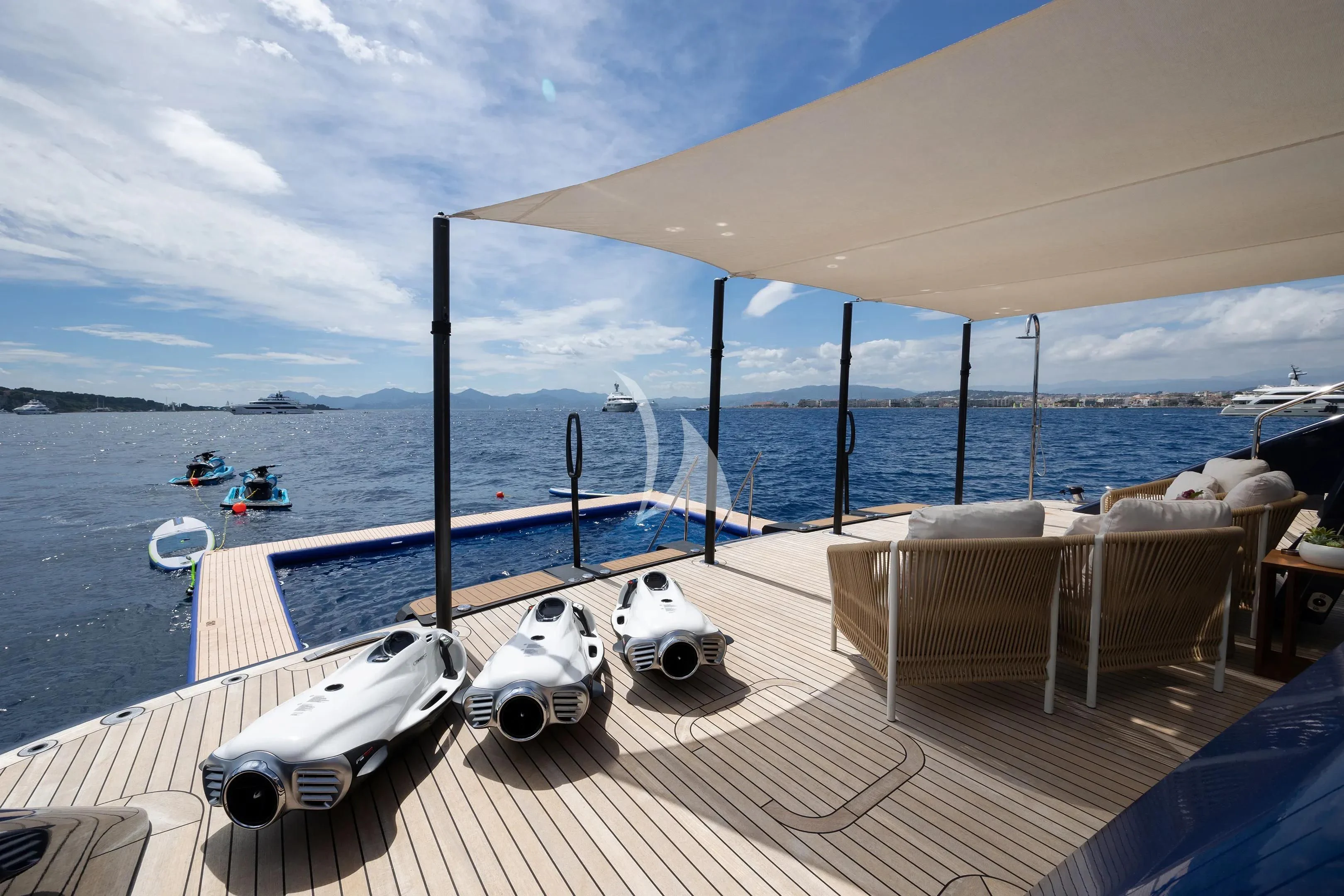 a deck with boats and chairs on it by the water aboard ZAZOU Yacht for Sale