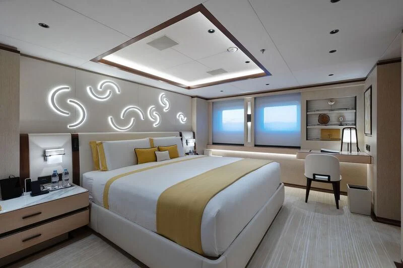 a room with a bed and a chair aboard ZAZOU Yacht for Sale