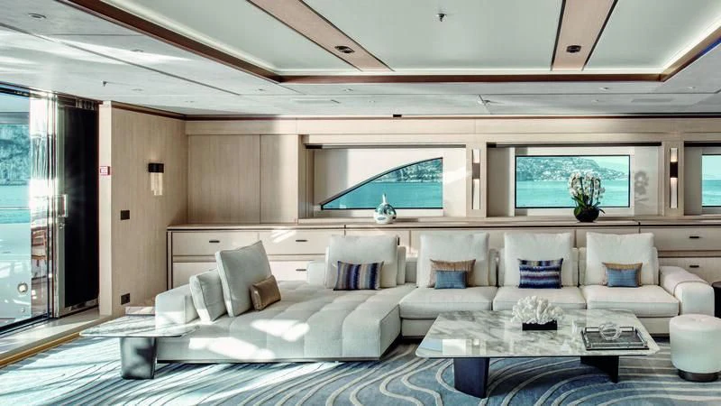 a large living room with a large white couch and a large window aboard ZAZOU Yacht for Sale