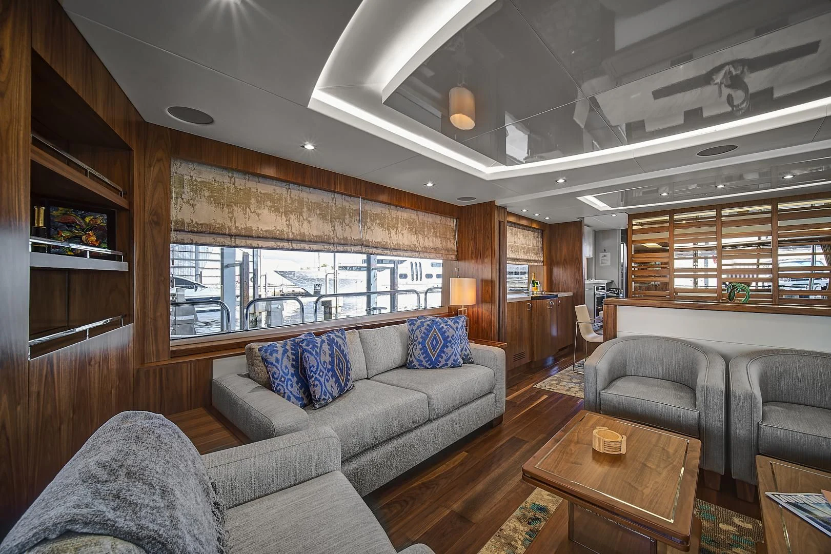 a living room with leather couches and a wood coffee table aboard 'S NOON SOMEWHERE Yacht for Sale