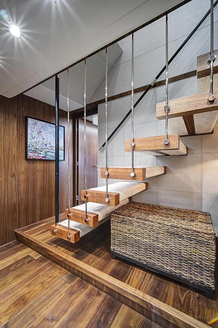 a room with a wood floor and a wood staircase aboard 'S NOON SOMEWHERE Yacht for Sale
