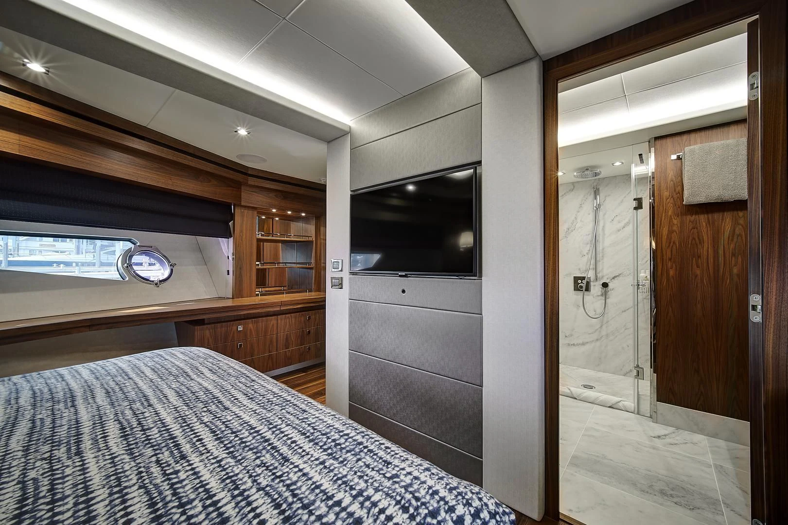 a bedroom with a bed and a television aboard 'S NOON SOMEWHERE Yacht for Sale