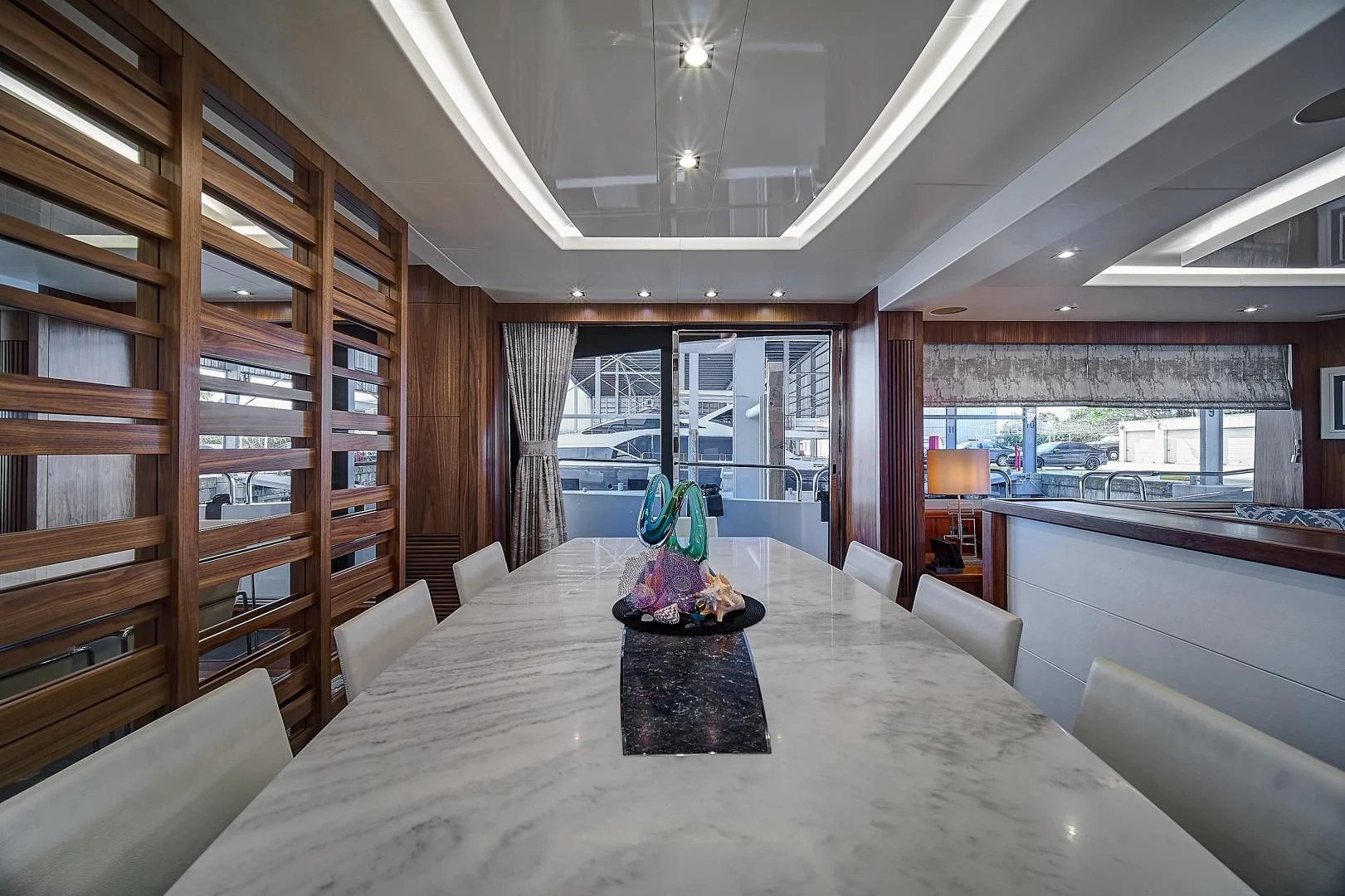 a large room with a table and chairs aboard 'S NOON SOMEWHERE Yacht for Sale