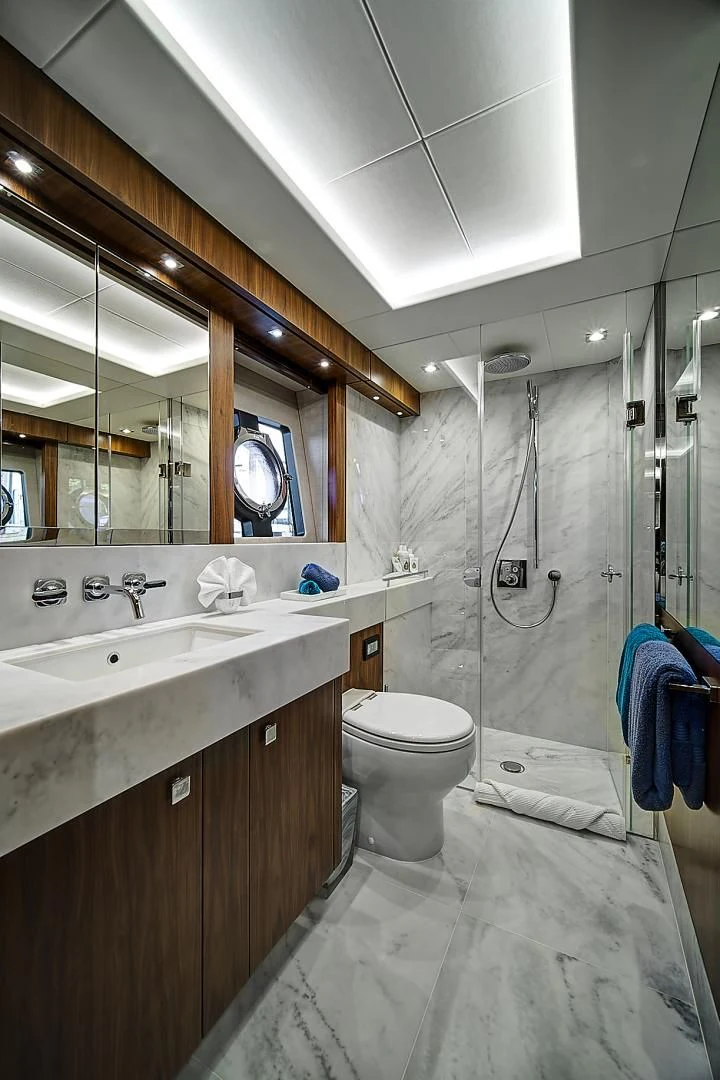 a bathroom with a sink toilet and a mirror aboard 'S NOON SOMEWHERE Yacht for Sale