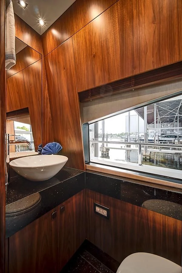 a bathroom with a sink and a large window aboard 'S NOON SOMEWHERE Yacht for Sale