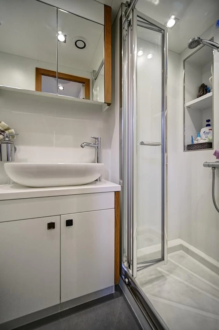 a bathroom with a sink and a mirror aboard 'S NOON SOMEWHERE Yacht for Sale