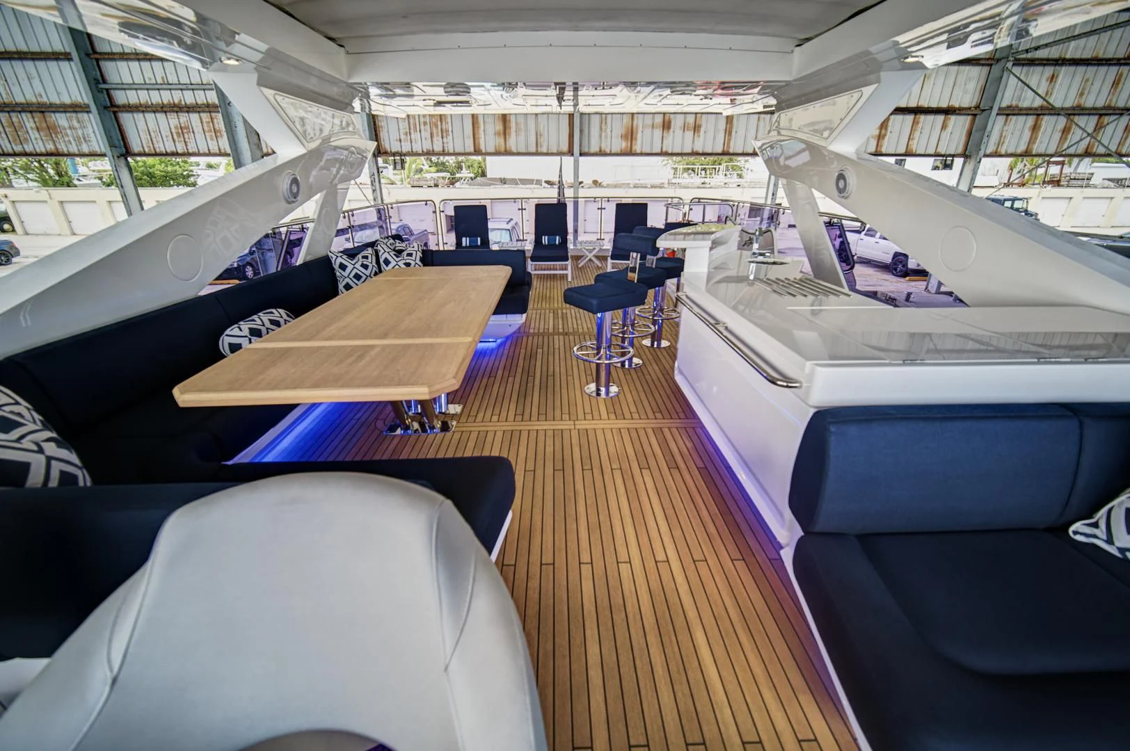 inside of a building with a wooden deck and chairs aboard 'S NOON SOMEWHERE Yacht for Sale