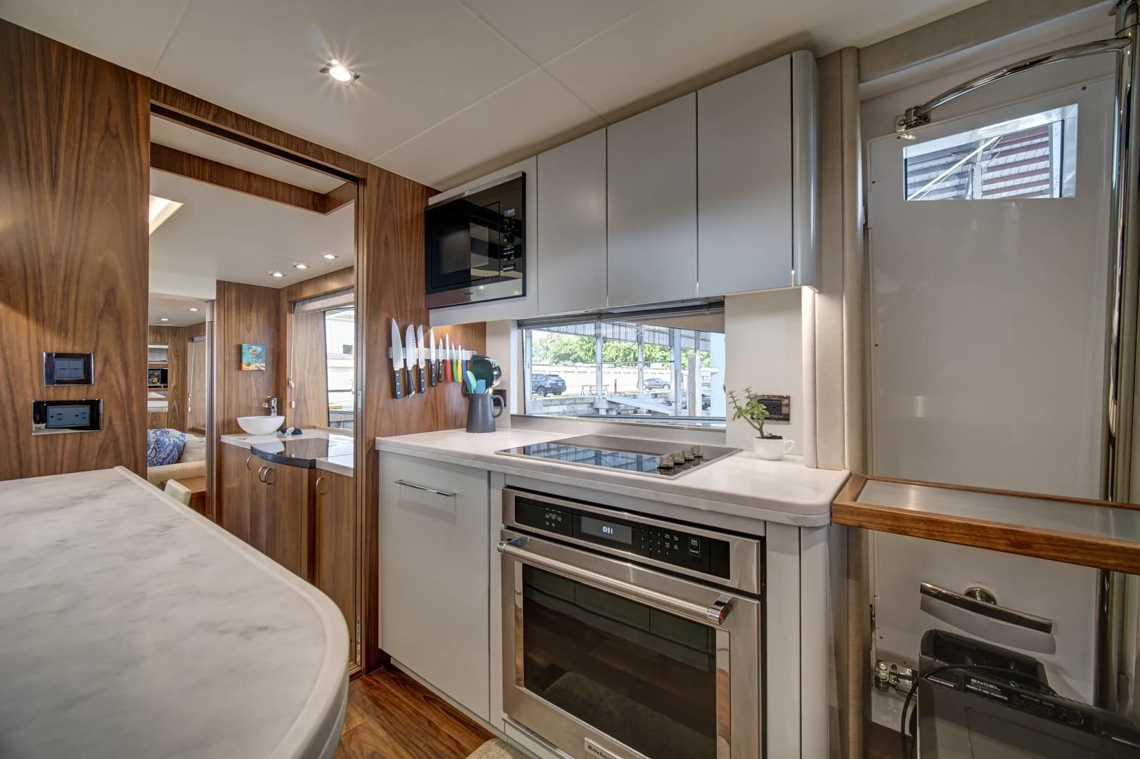 a kitchen with a refrigerator and sink aboard 'S NOON SOMEWHERE Yacht for Sale