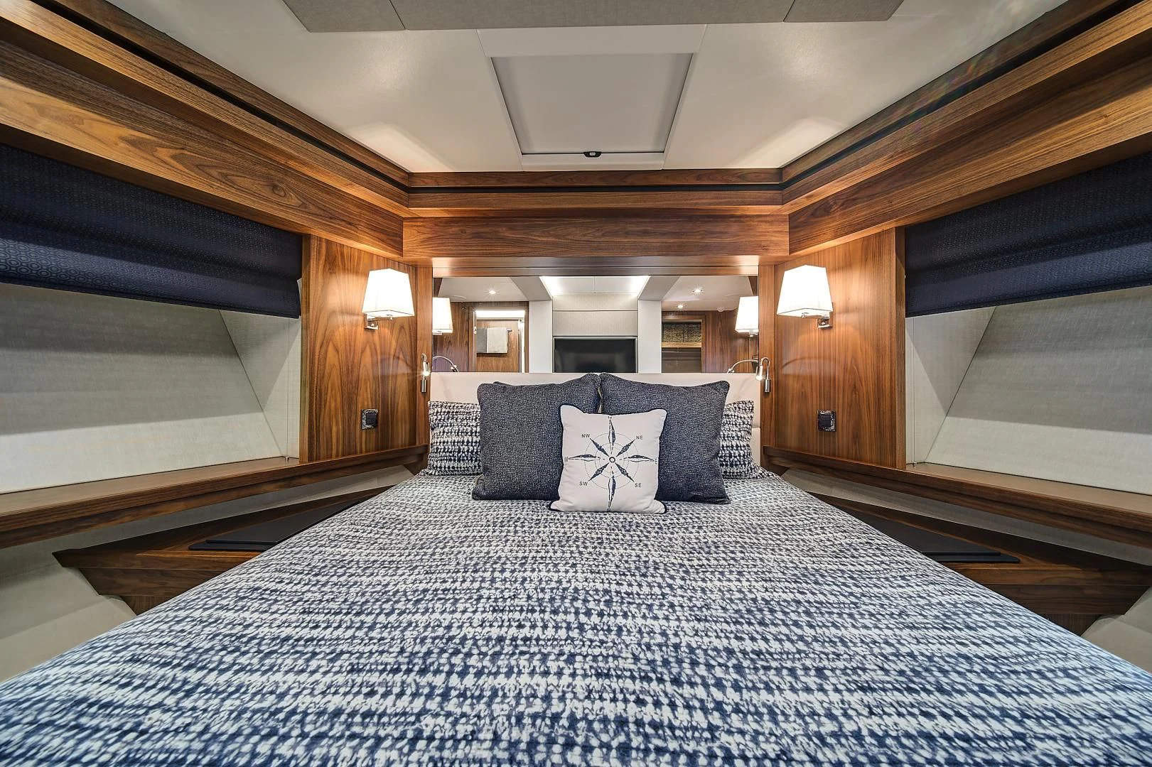 a bed with a blue and white bed spread aboard 'S NOON SOMEWHERE Yacht for Sale