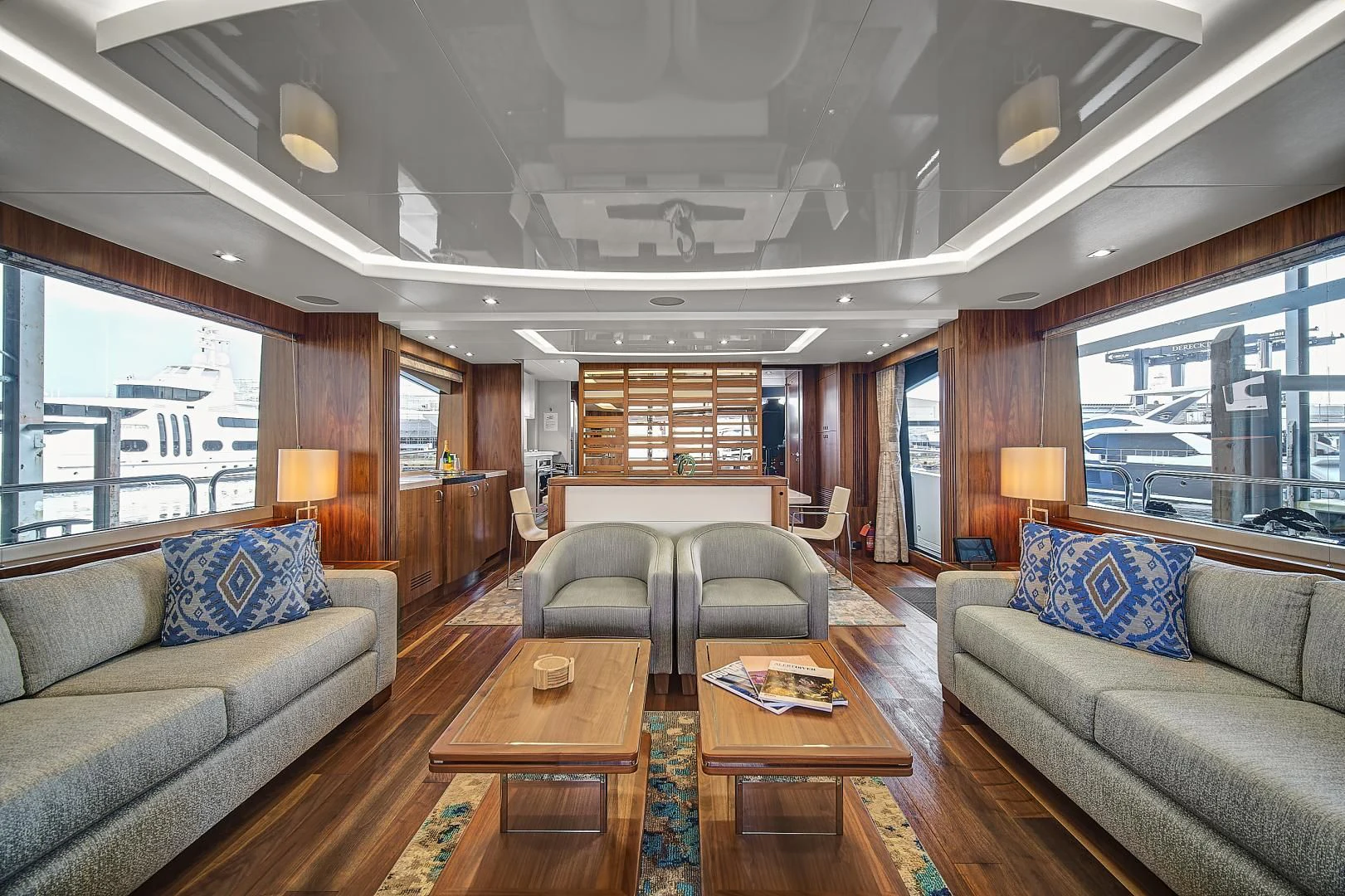 a living room with a wood table and couches aboard 'S NOON SOMEWHERE Yacht for Sale