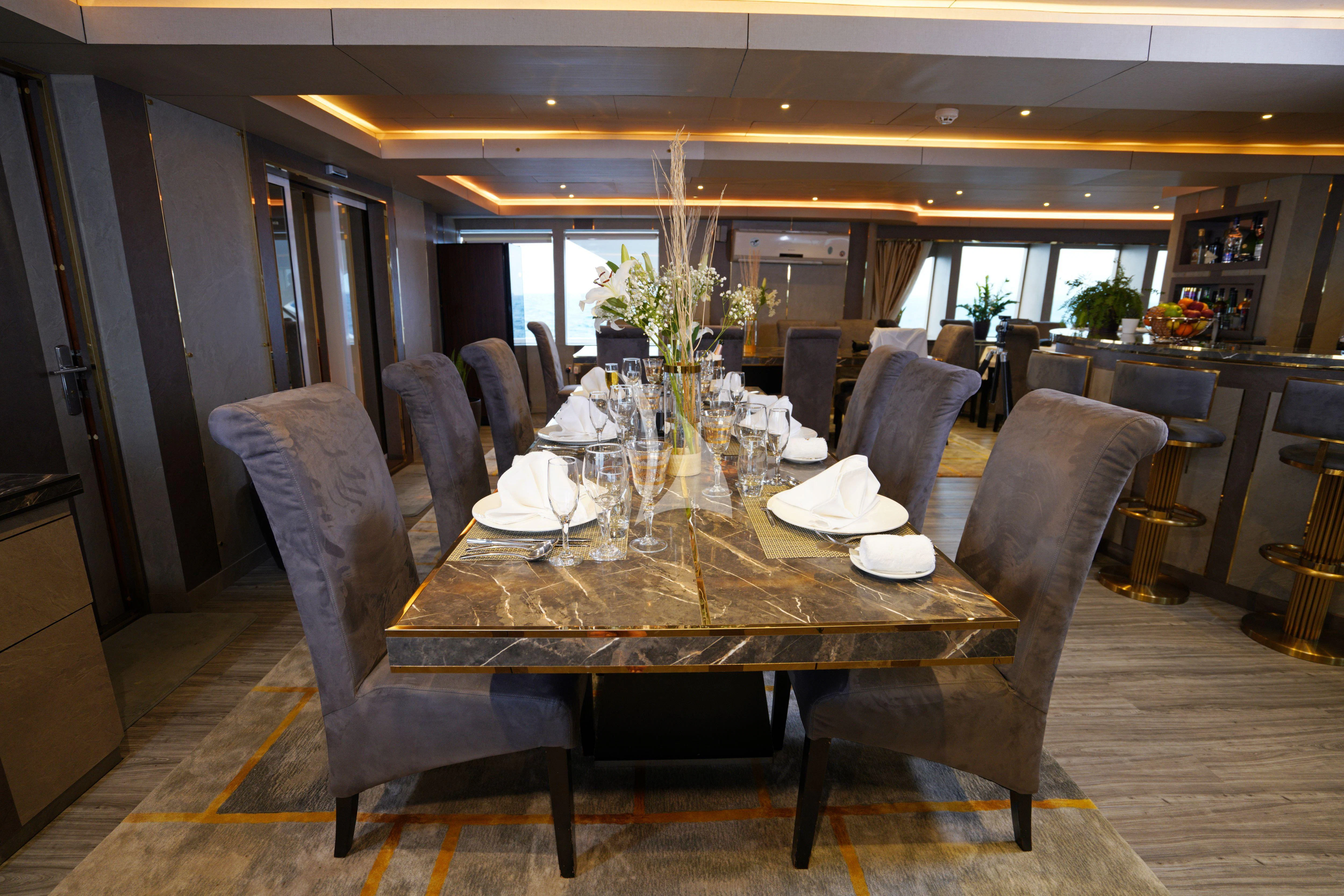 a dining room with a table and chairs aboard ARK NOBLE Yacht for Sale