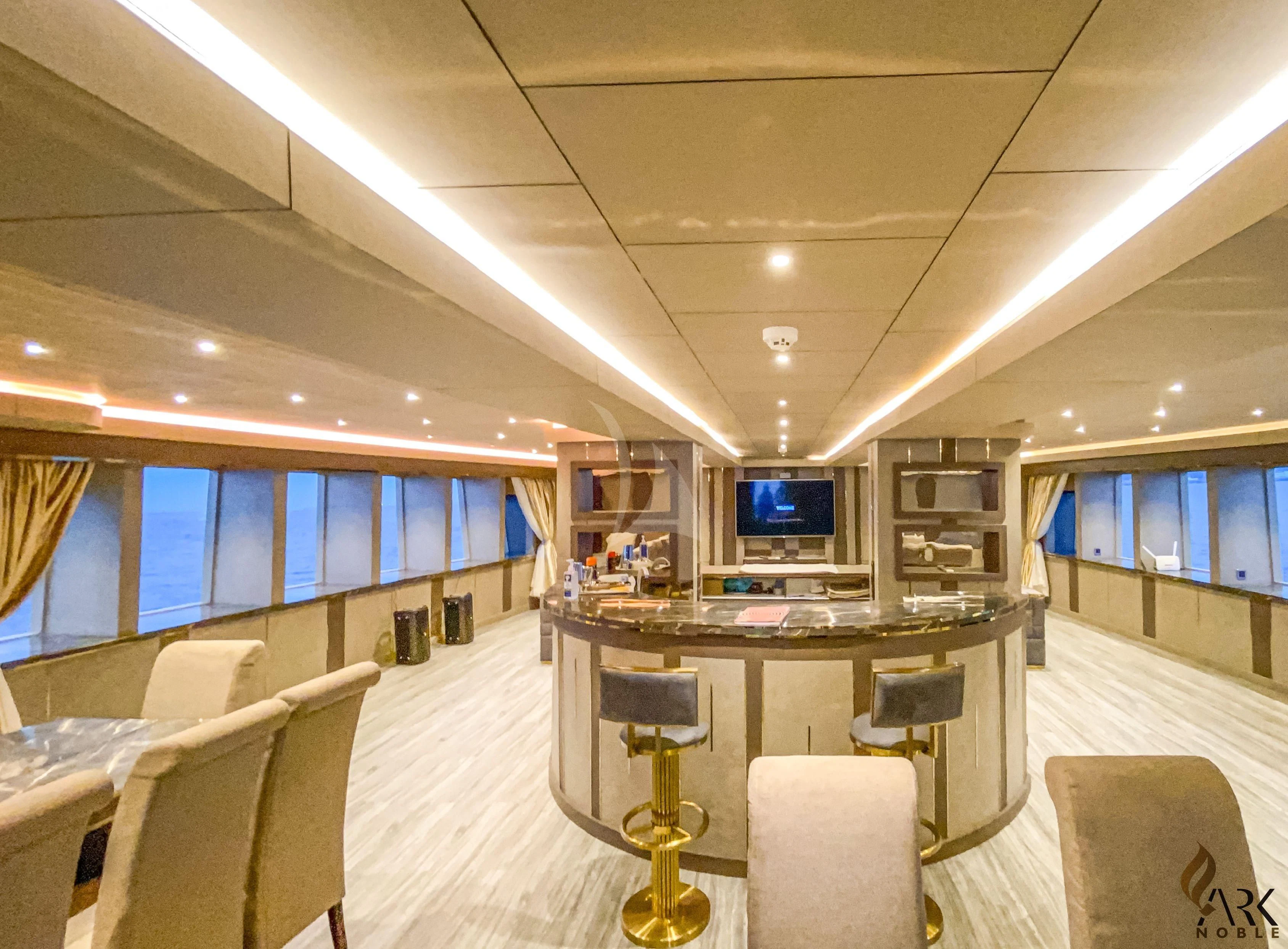 inside of a building with a table and chairs and a tv aboard ARK NOBLE Yacht for Sale