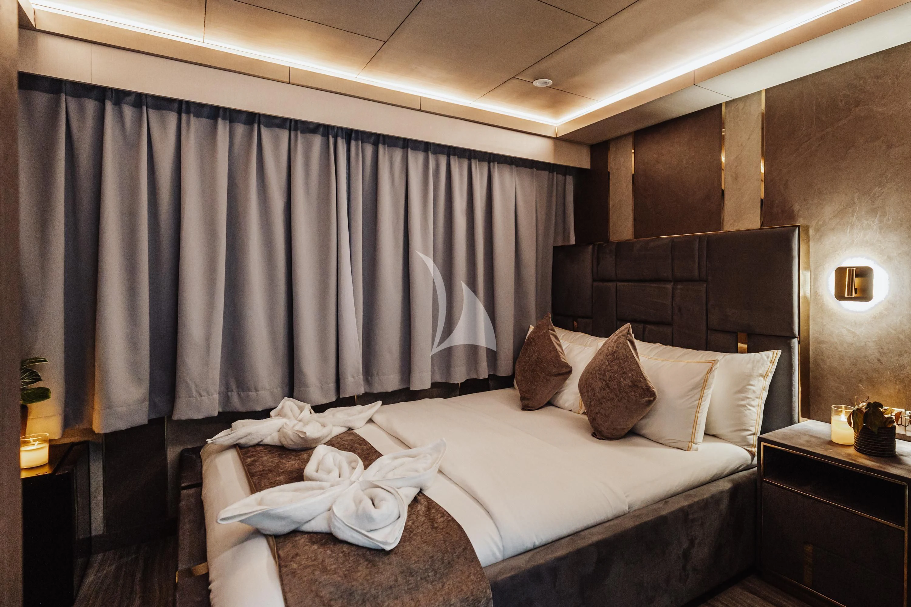 a bed with a white sheet and pillows aboard ARK NOBLE Yacht for Sale