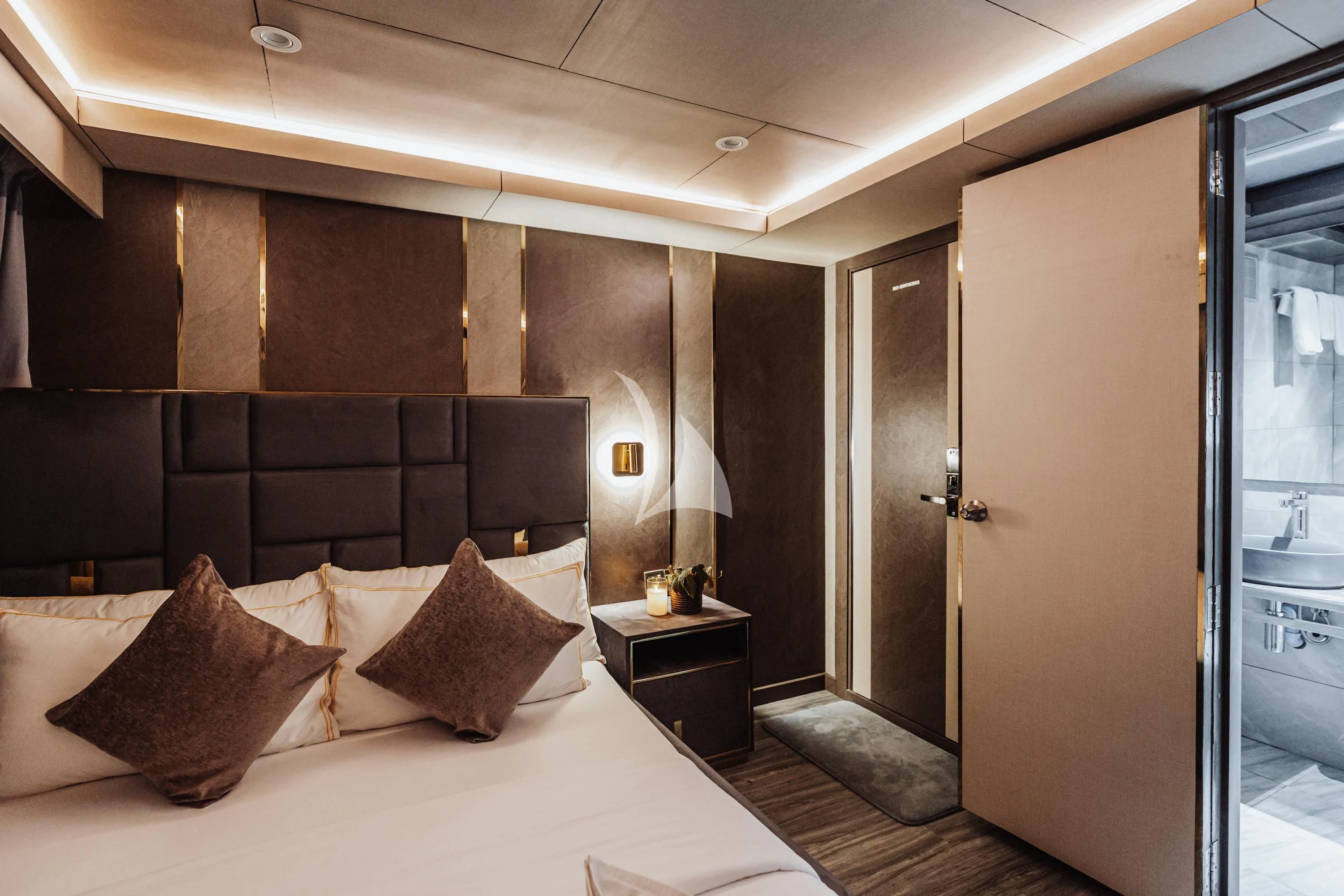 a hotel room with a bed and a desk aboard ARK NOBLE Yacht for Sale