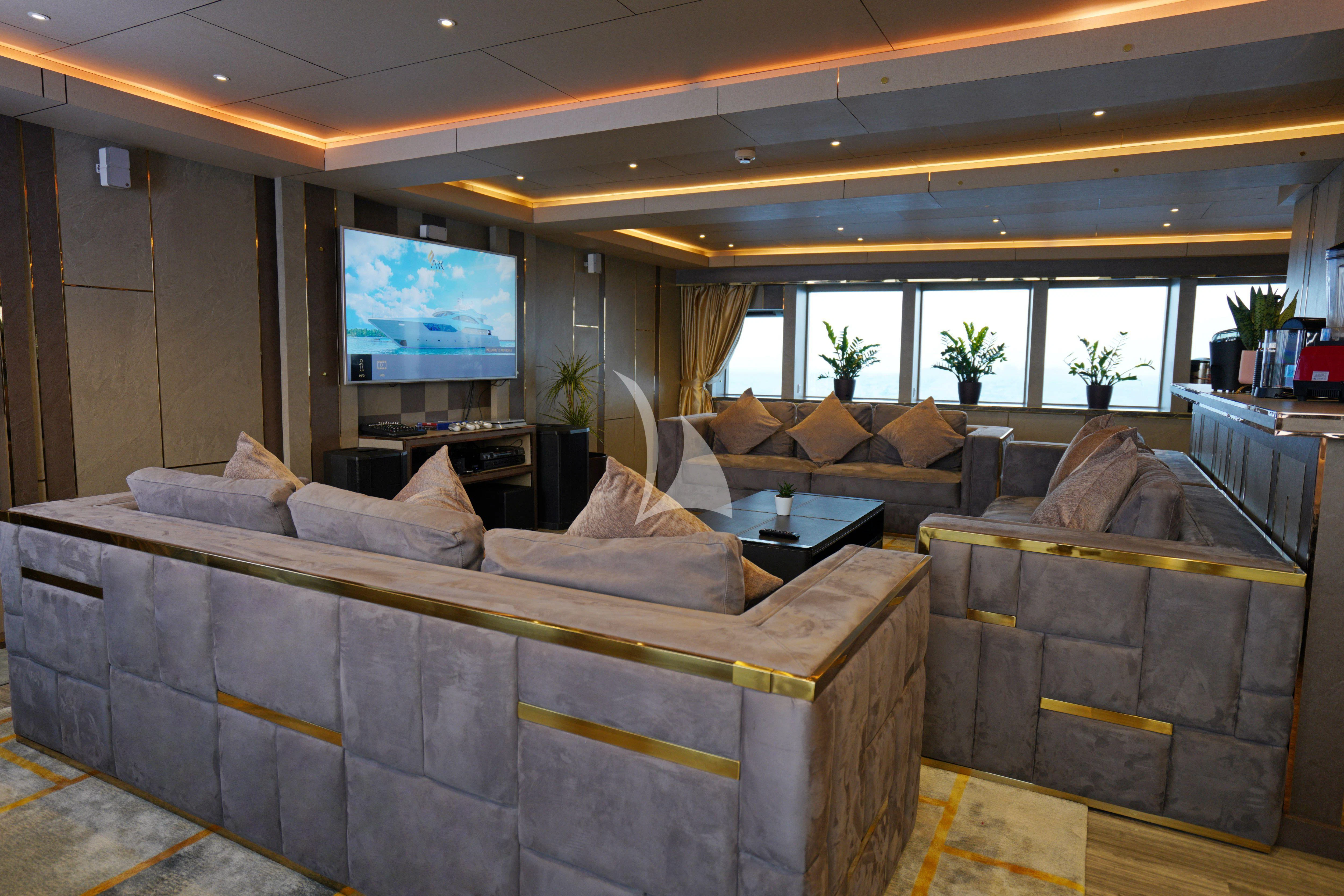 a living room with a couch and a tv aboard ARK NOBLE Yacht for Sale